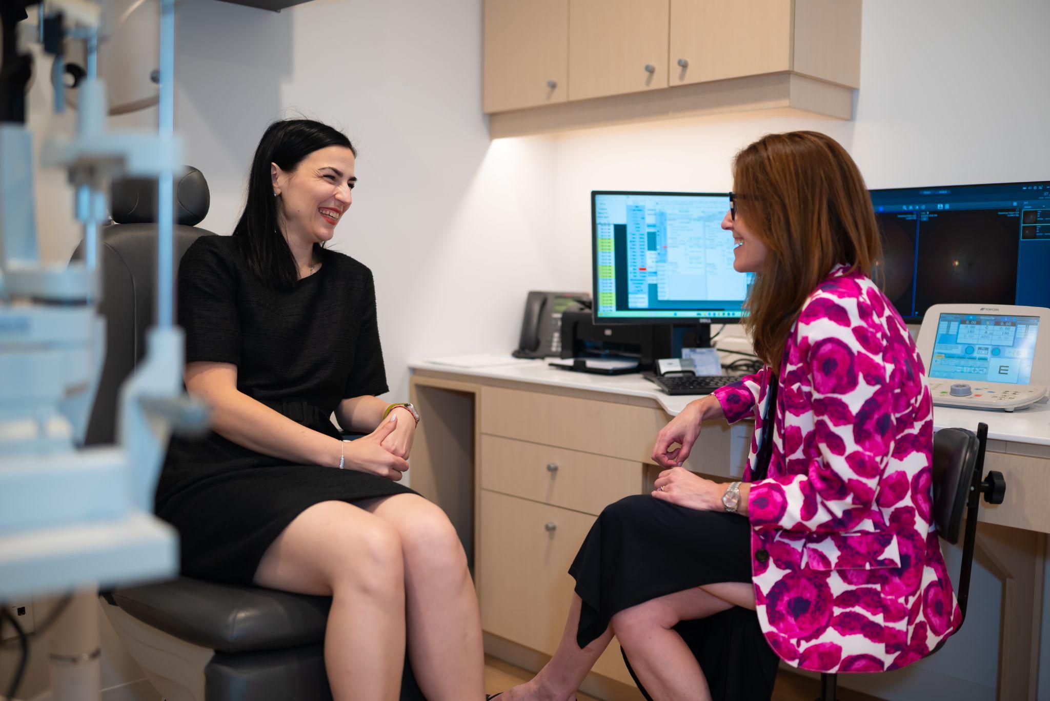 an eye doctor talking to a professional who is getting an eye exam done during their lunch break.